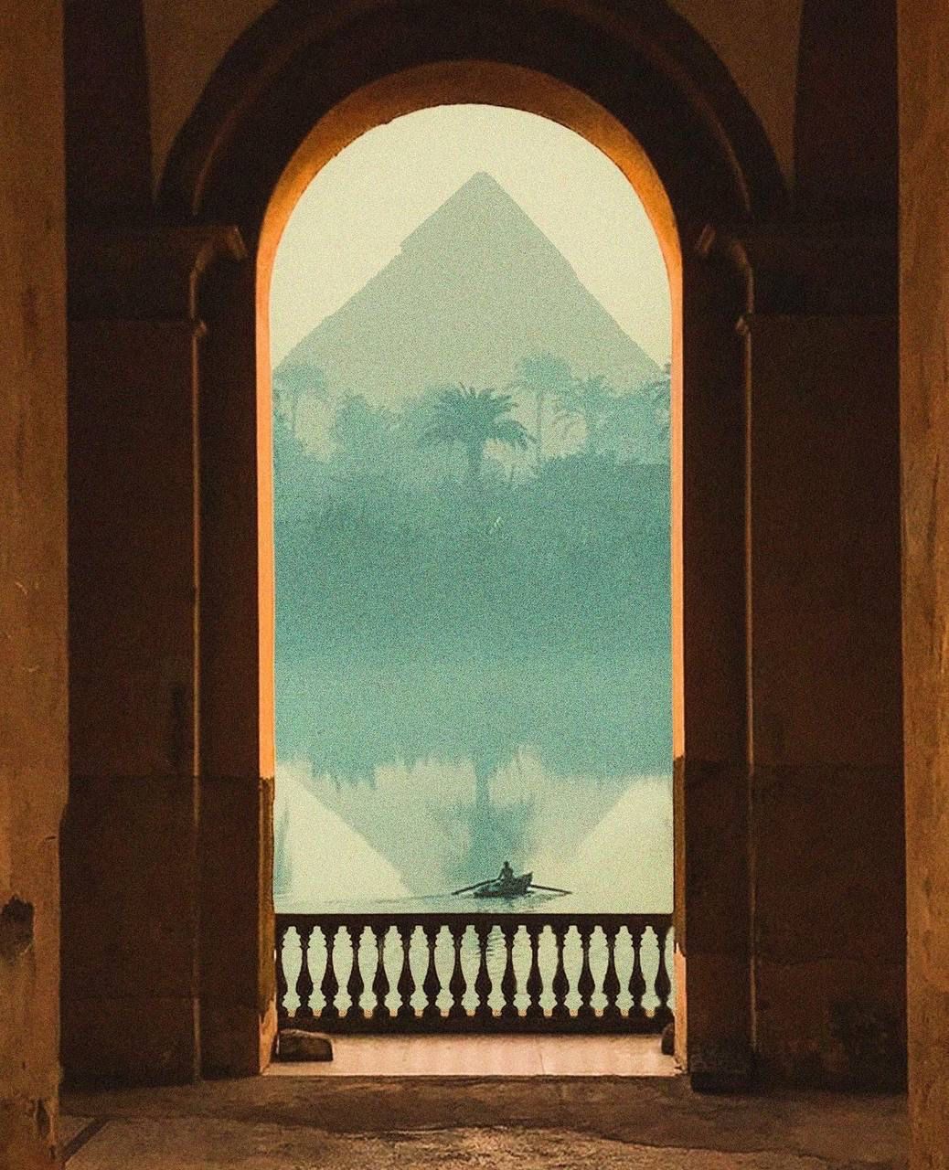 Framed pyramid view through monumental Egyptian archway