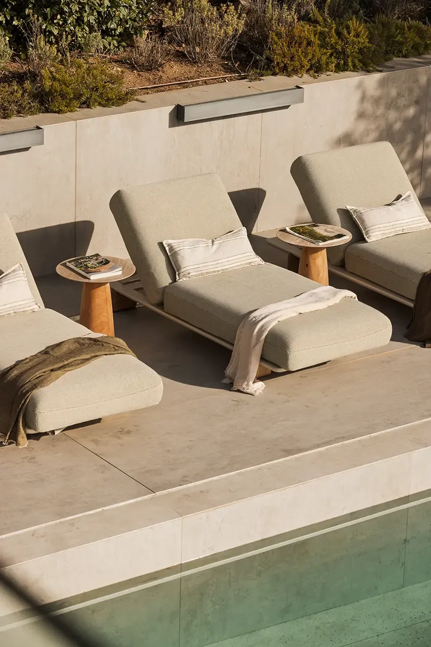 Inviting outdoor lounge area with contemporary seating arrangements, soft neutral tones, and beautiful natural surroundings. The space is perfect for relaxing or enjoying a quiet moment.