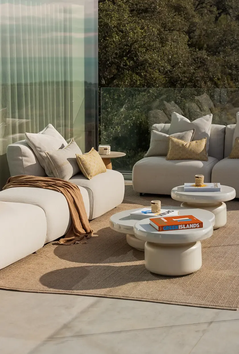 Elegant terrace with comfortable lounge chairs and stylish side tables, offering a serene outdoor retreat. The natural light and open views create an ideal setting for outdoor relaxation and contemplation.
