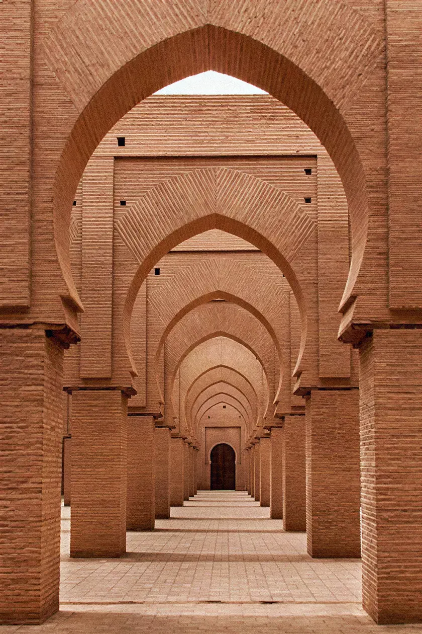 Rhythmic sequence of brick arches and colonnades showcasing geometric symmetry and traditional North African architectural design.