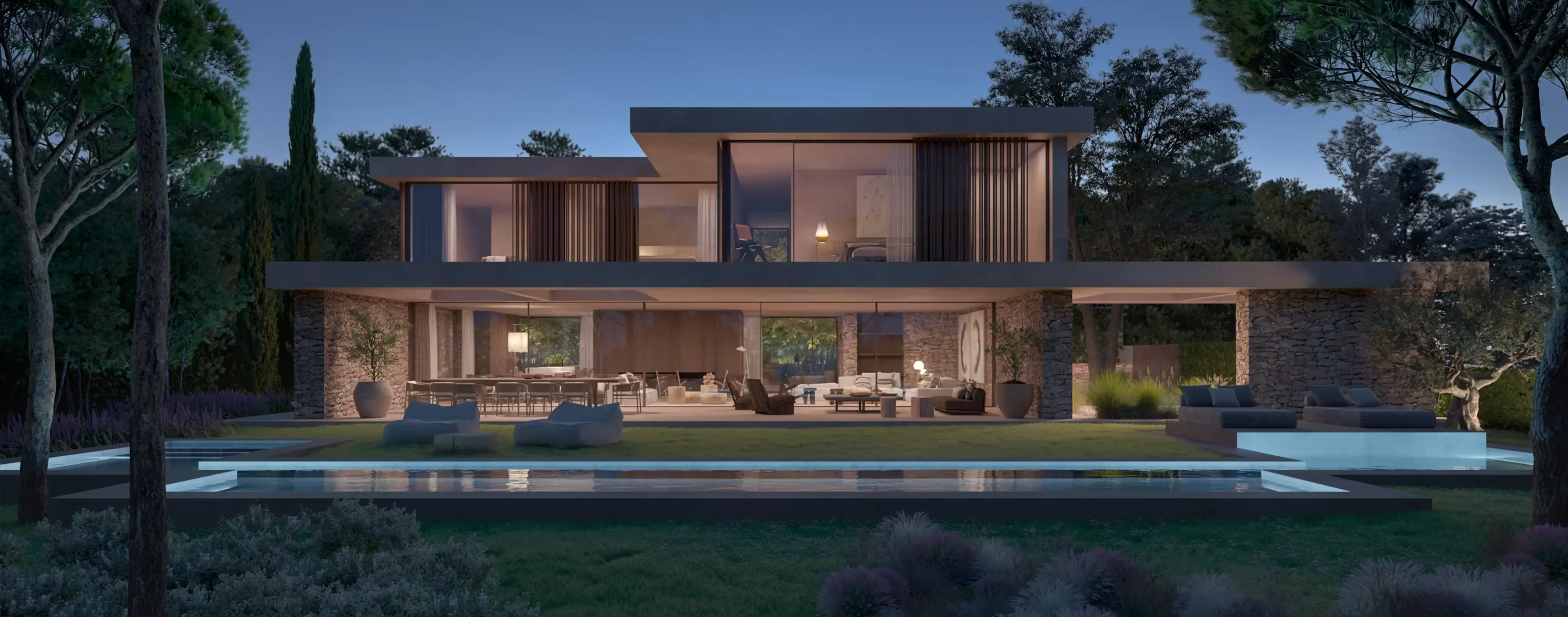 Modern villa at dusk with warm interior lighting, designed by Luv Studio to blend luxury and nature in perfect harmony.