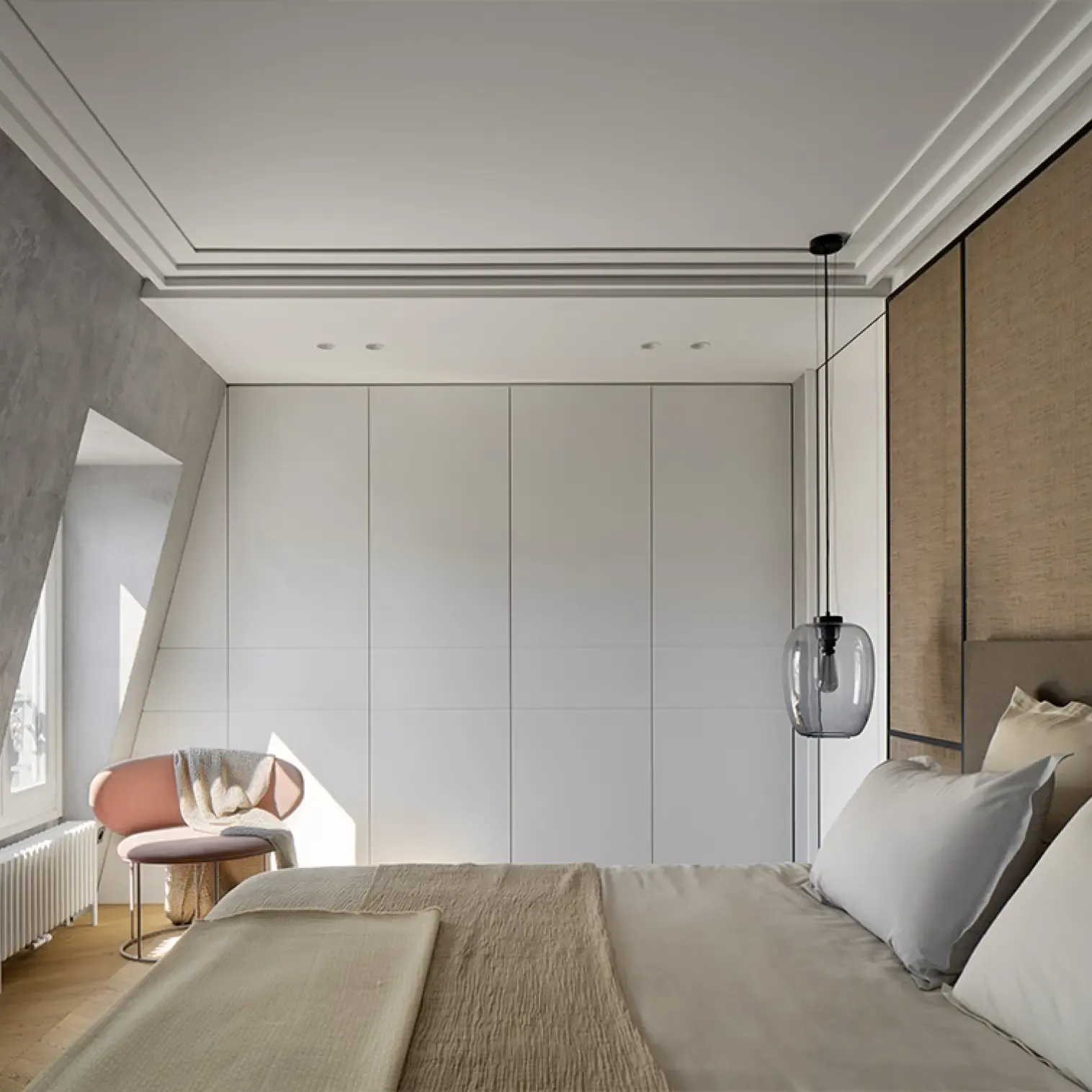 Minimalist bedroom with neutral tones, upholstered headboard, built-in white wardrobes, and soft natural light through a side window.