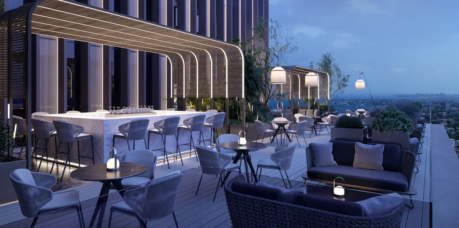 Panoramic rooftop bar with ambient lighting, marble counter, modern seating, and stunning views of the city skyline.