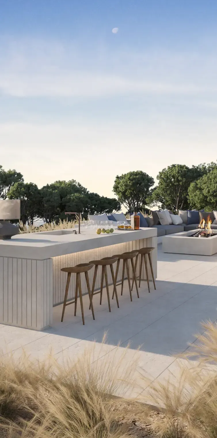 Rooftop terrace with outdoor kitchen, bar seating, and fire pit surrounded by Mediterranean landscape.