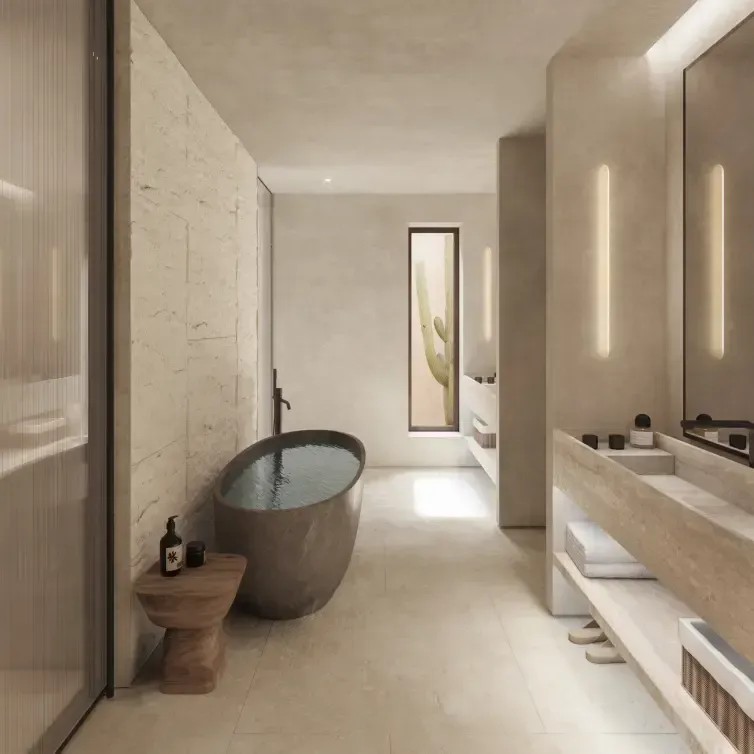 Minimalist luxury bathroom interior featuring natural stone, sculptural bathtub, and cactus view window.