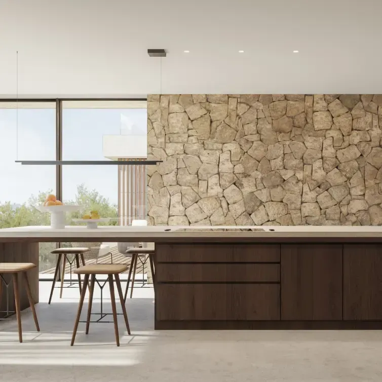 Minimalist kitchen with a central island, natural stone wall, and panoramic glazing.