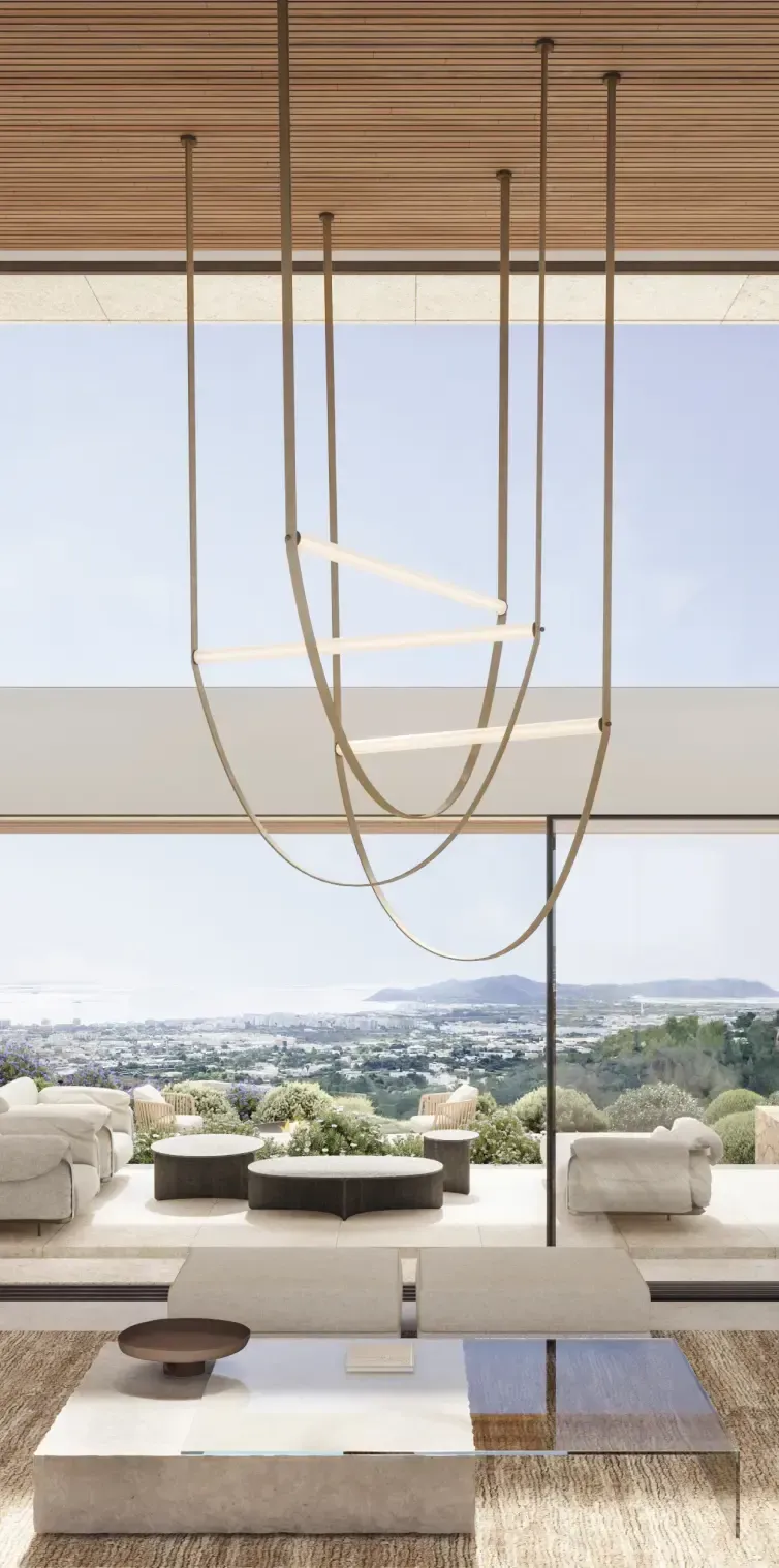 Double-height living room with full-height windows overlooking the hills and coastline.