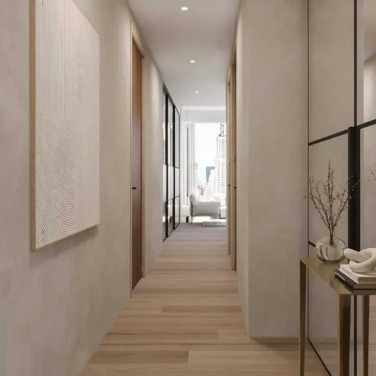 Sleek hallway with warm wood flooring and curated decor, leading to a city-view lounge in a Luv studio project.
