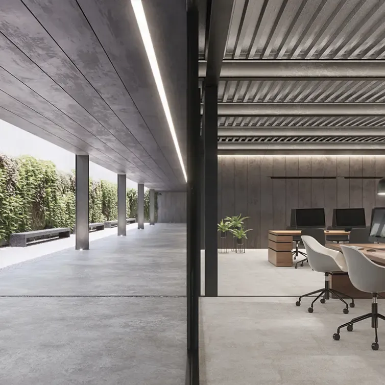 Seamless indoor-outdoor workspace with green wall and minimalist concrete design.