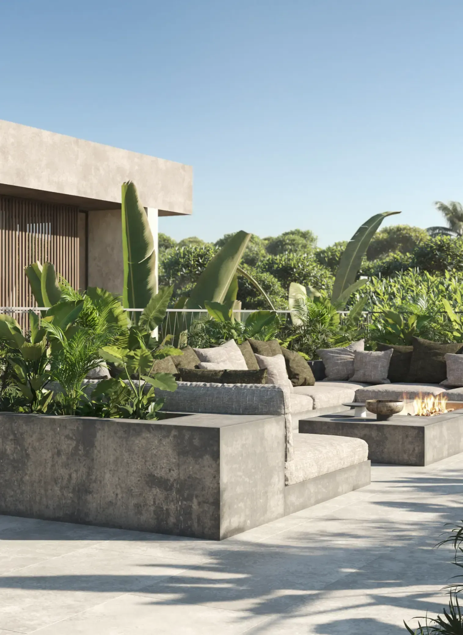 Lush rooftop terrace with built-in seating, tropical landscaping, and firepit feature.