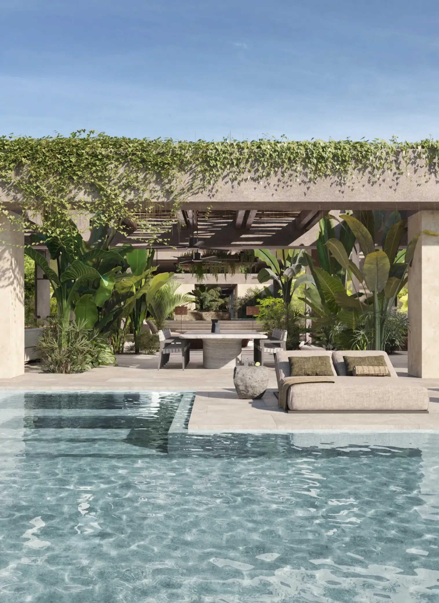 Luxury tropical villa with a shaded lounge area and pool surrounded by lush greenery.