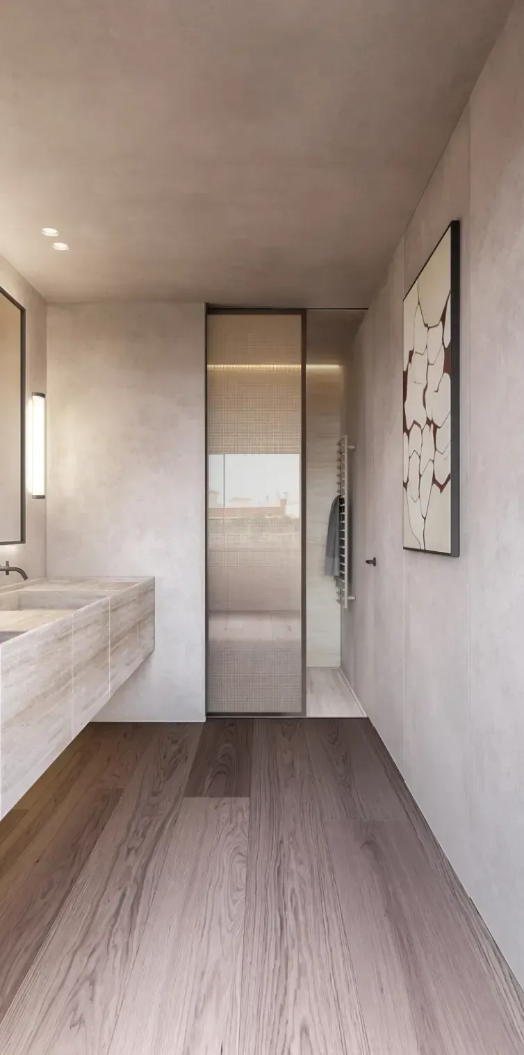 Elegant bathroom interior with travertine sink and modern finishes by Luv Studio, showcasing luxury architecture in Barcelona.