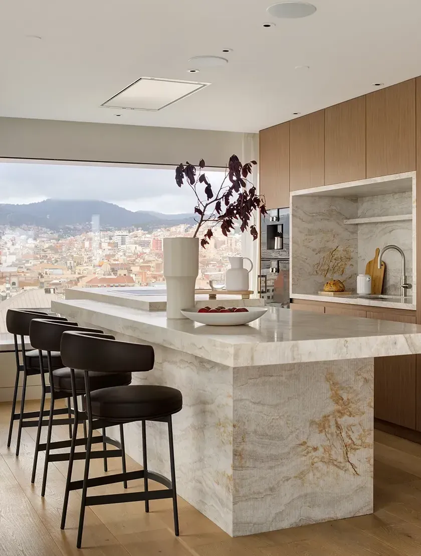 Elegant marble kitchen with panoramic city view, showcasing luxury design and natural light at Mandarin Oriental Residences.