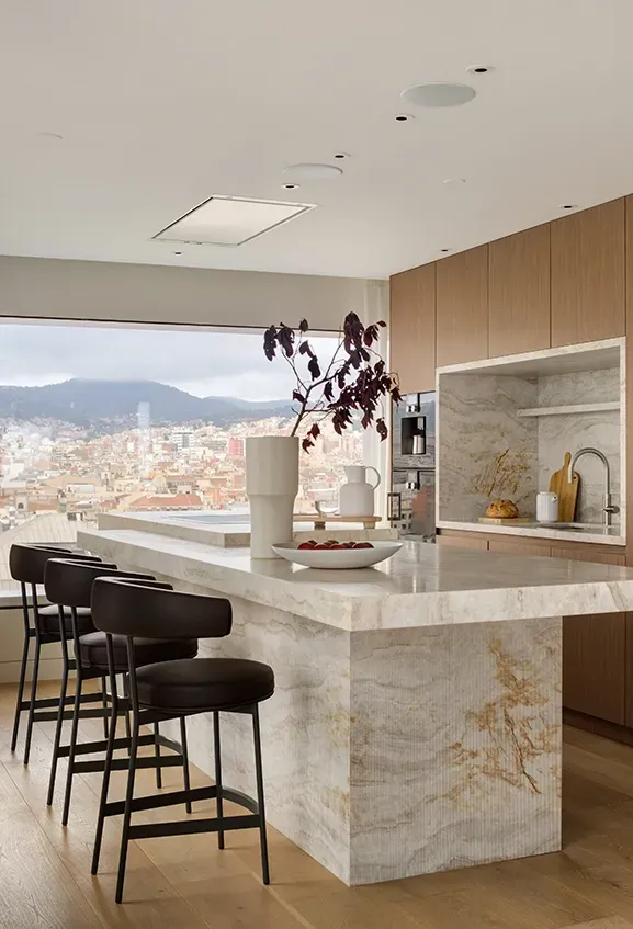 Elegant marble kitchen with panoramic city view, showcasing luxury design and natural light at Mandarin Oriental Residences.