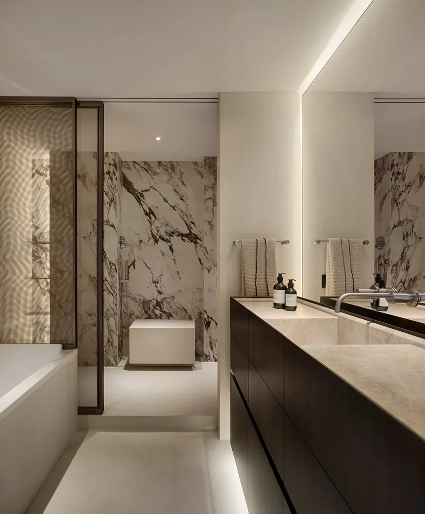 Luxurious bathroom featuring marble walls, double vanity, and ambient lighting at Mandarin Oriental Residences.