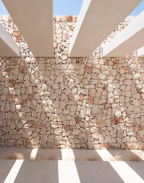 A pergola-topped entryway blending shade, texture, and warmth.