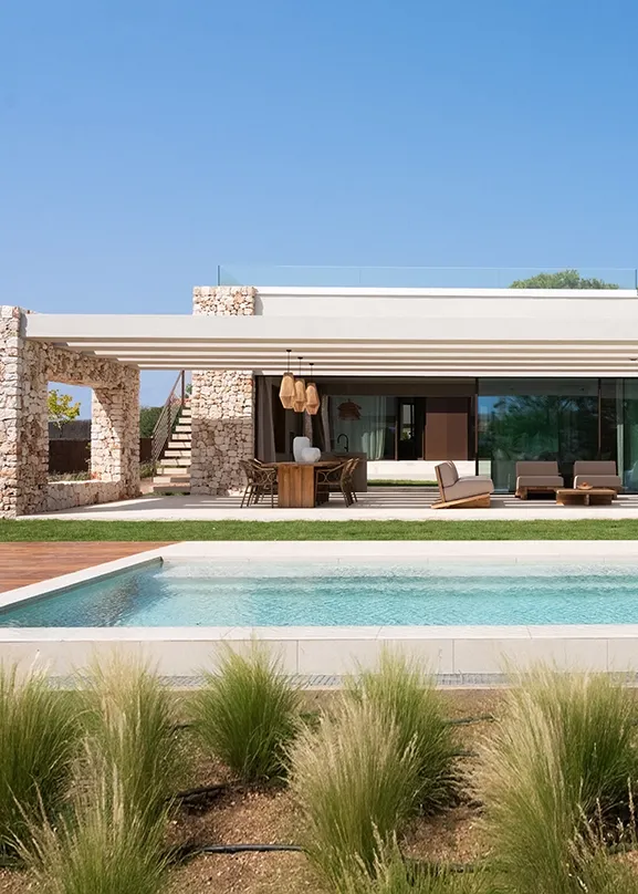 A contemporary façade rooted in tradition, blending lime stucco with natural textures.