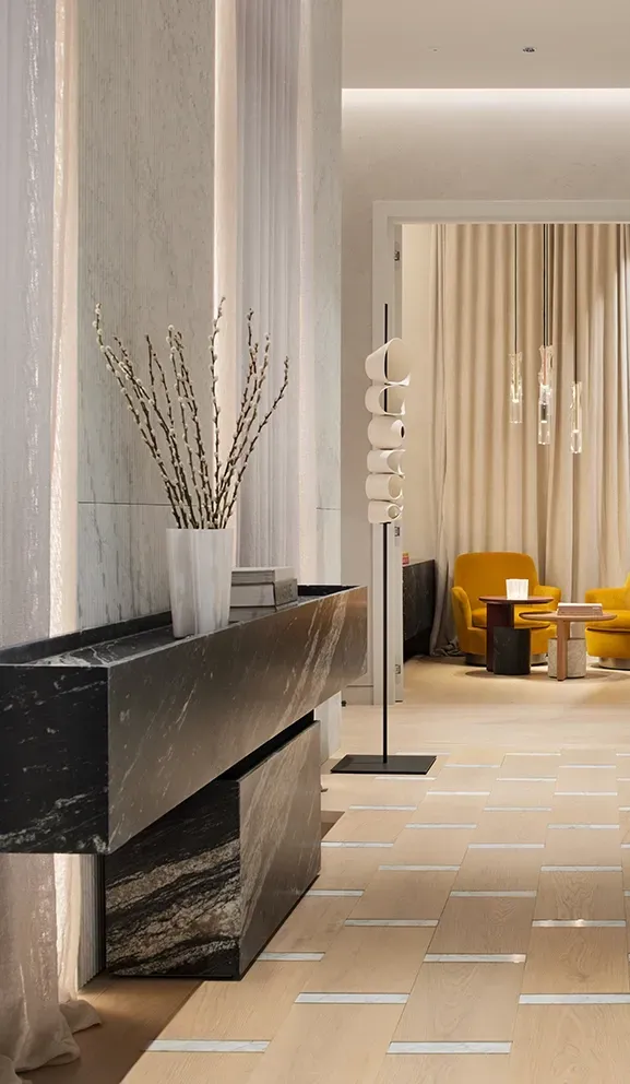 Elegant hallway view into lounge with mustard chairs, blending comfort and modern architecture.