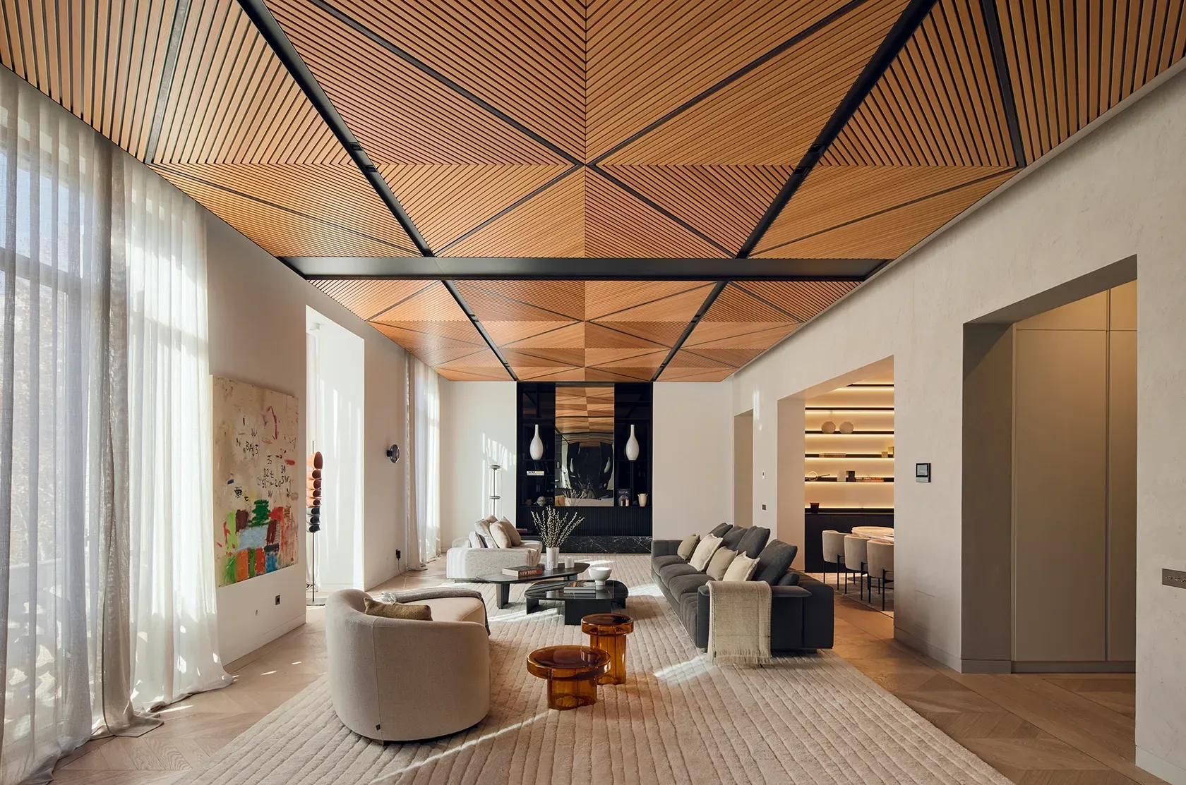 Modern living room with geometric wood ceiling and curated luxury architecture elements.