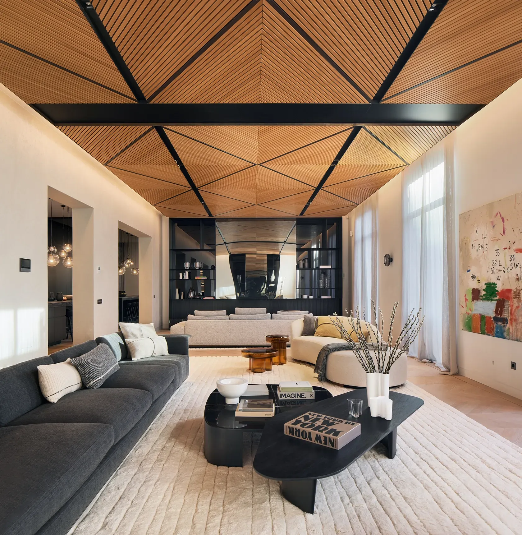 Contemporary living room with sculptural decor and luxury finishes under a striking wood ceiling.