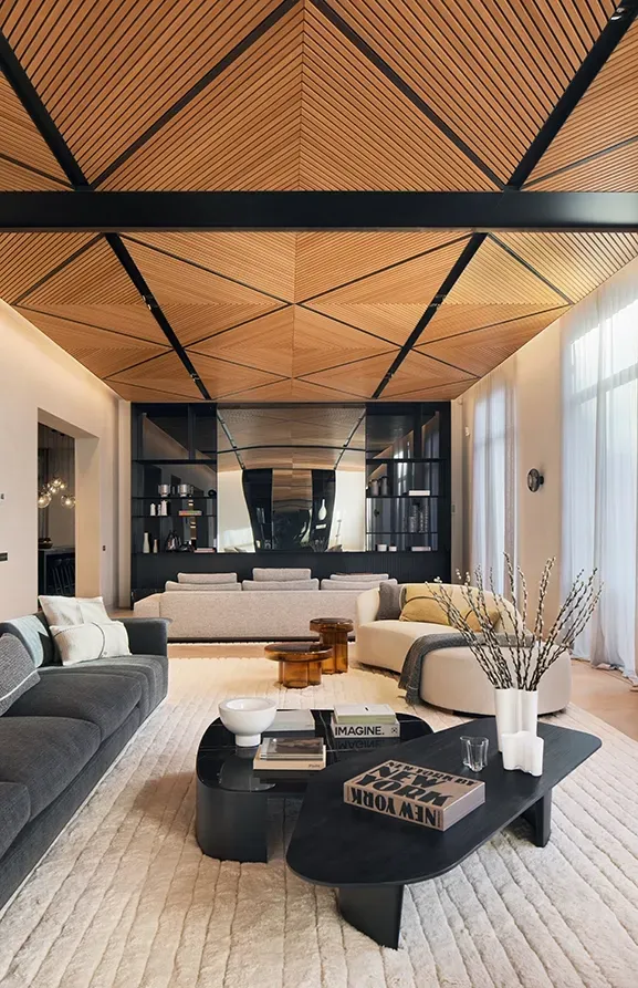 Contemporary living room with sculptural decor and luxury finishes under a striking wood ceiling.