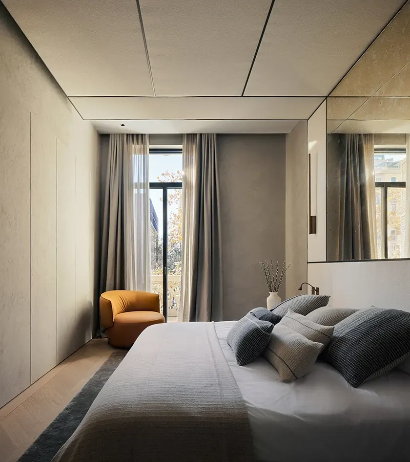 Sophisticated bedroom with neutral tones, modern textiles, and refined architectural lines.