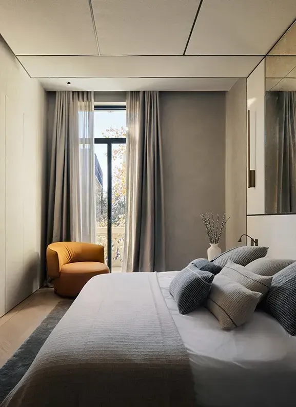 Sophisticated bedroom with neutral tones, modern textiles, and refined architectural lines.