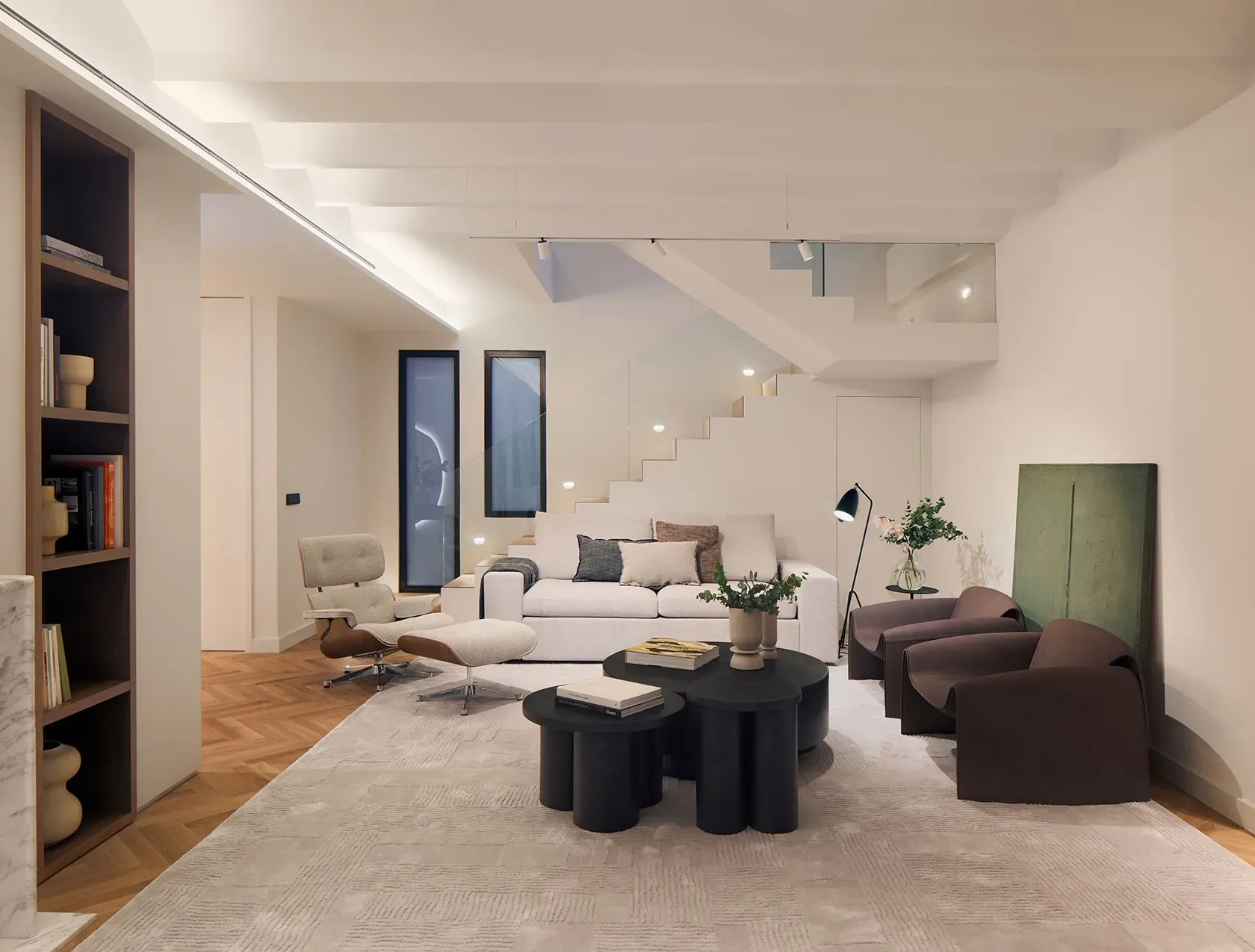Contemporary living room with elegant staircase and designer furniture in a luxury Pedralbes penthouse.