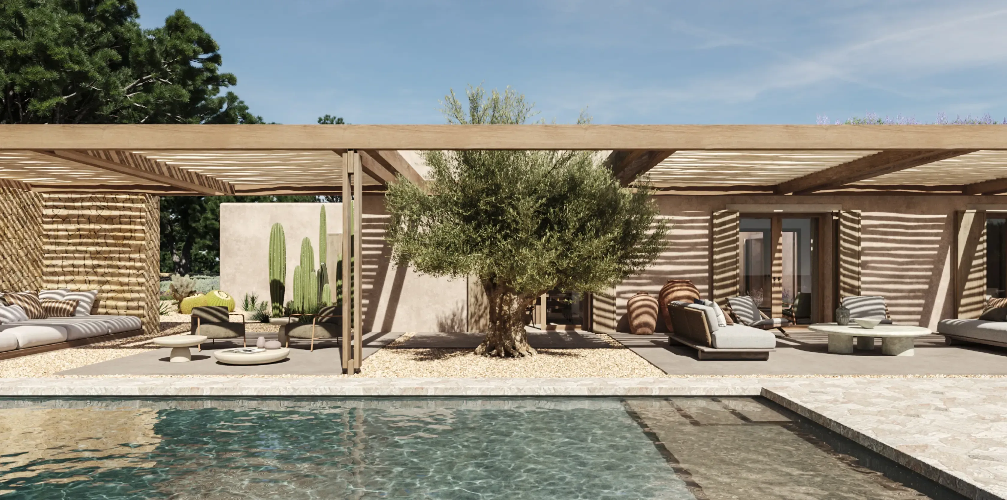 Chic villa poolside with olive tree, desert-style landscaping, and shaded outdoor sofas in Formentera.