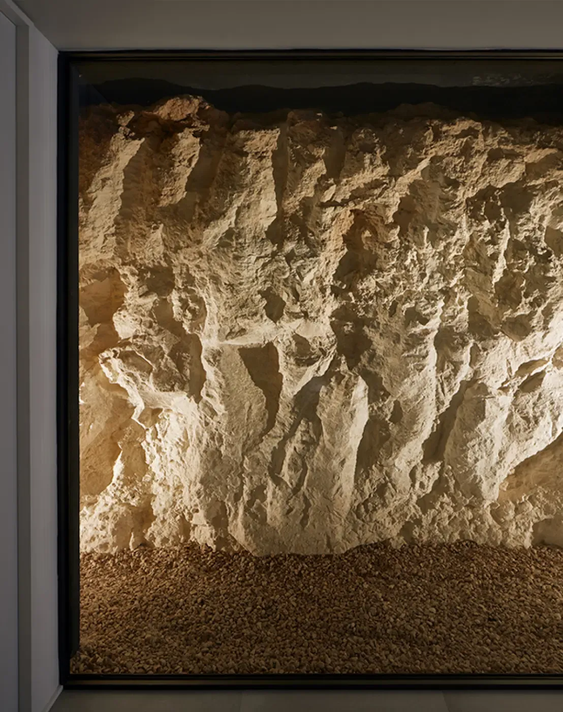 Illuminated rock wall installation, showcasing raw texture and earthy tones as a natural interior feature.