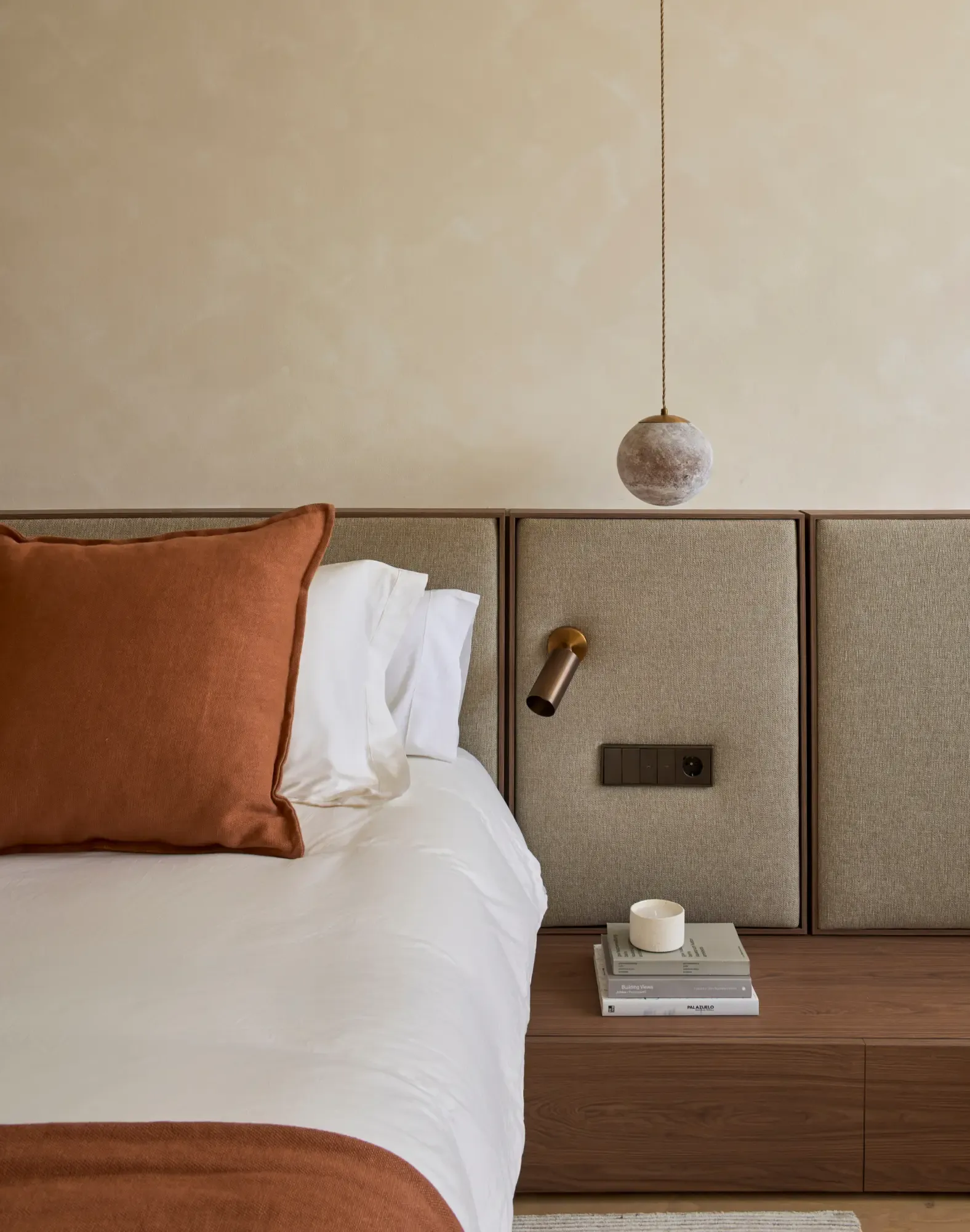Mediterranean-inspired bedroom with neutral tones, natural linens and warm wooden details