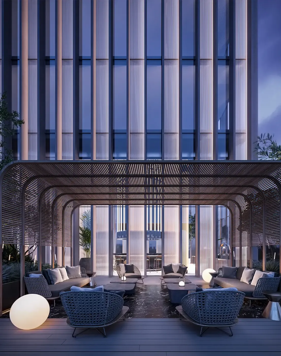 Evening terrace with woven canopy, lounge seating, and moody lighting in an urban luxury setting.