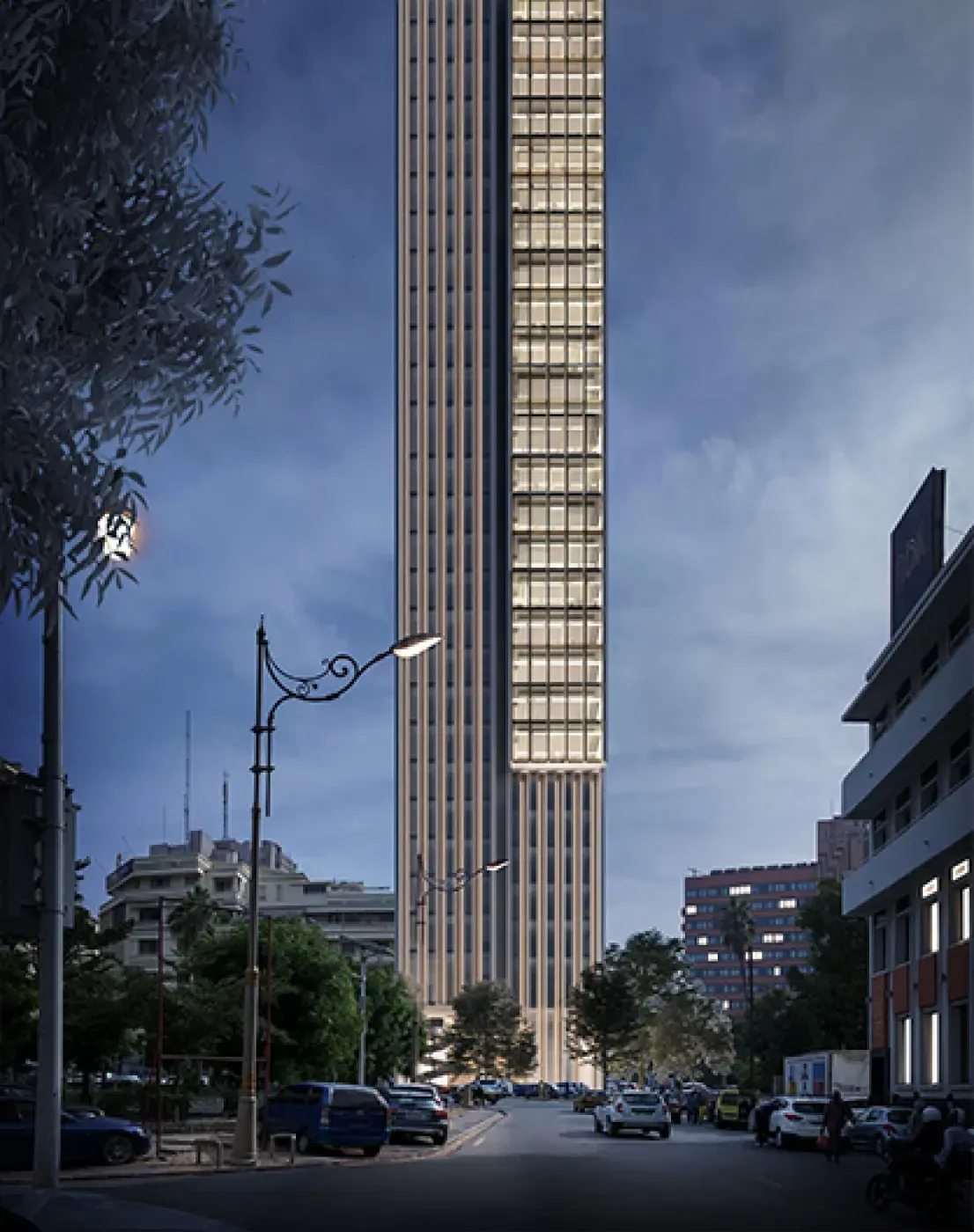 Nighttime perspective of the Energy Tower with illuminated windows and elegant vertical silhouette contrasting the evening sky.