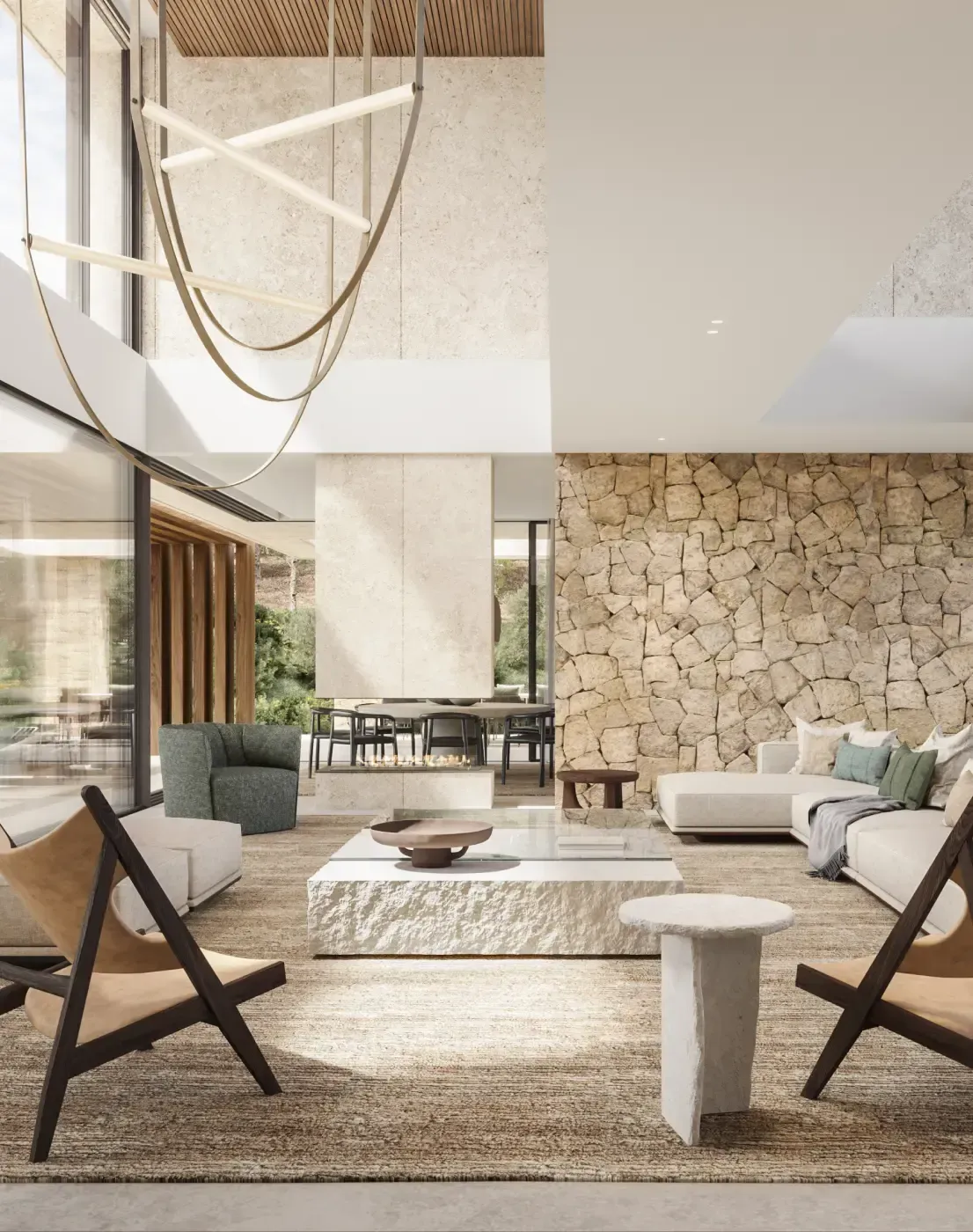 Interior stone wall with designer furniture in a bright, open-plan living area.