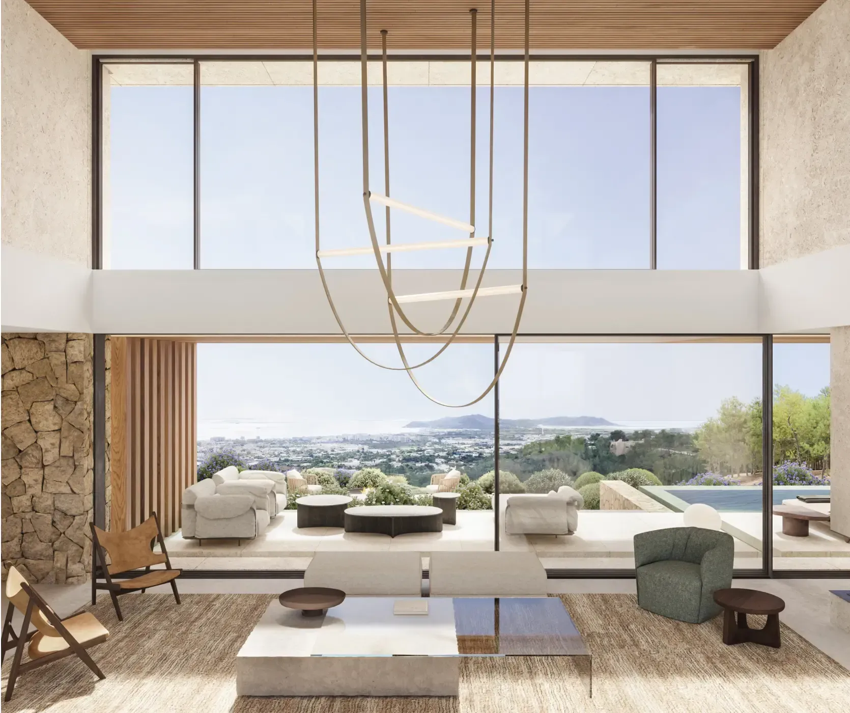Double-height living room with full-height windows overlooking the hills and coastline.