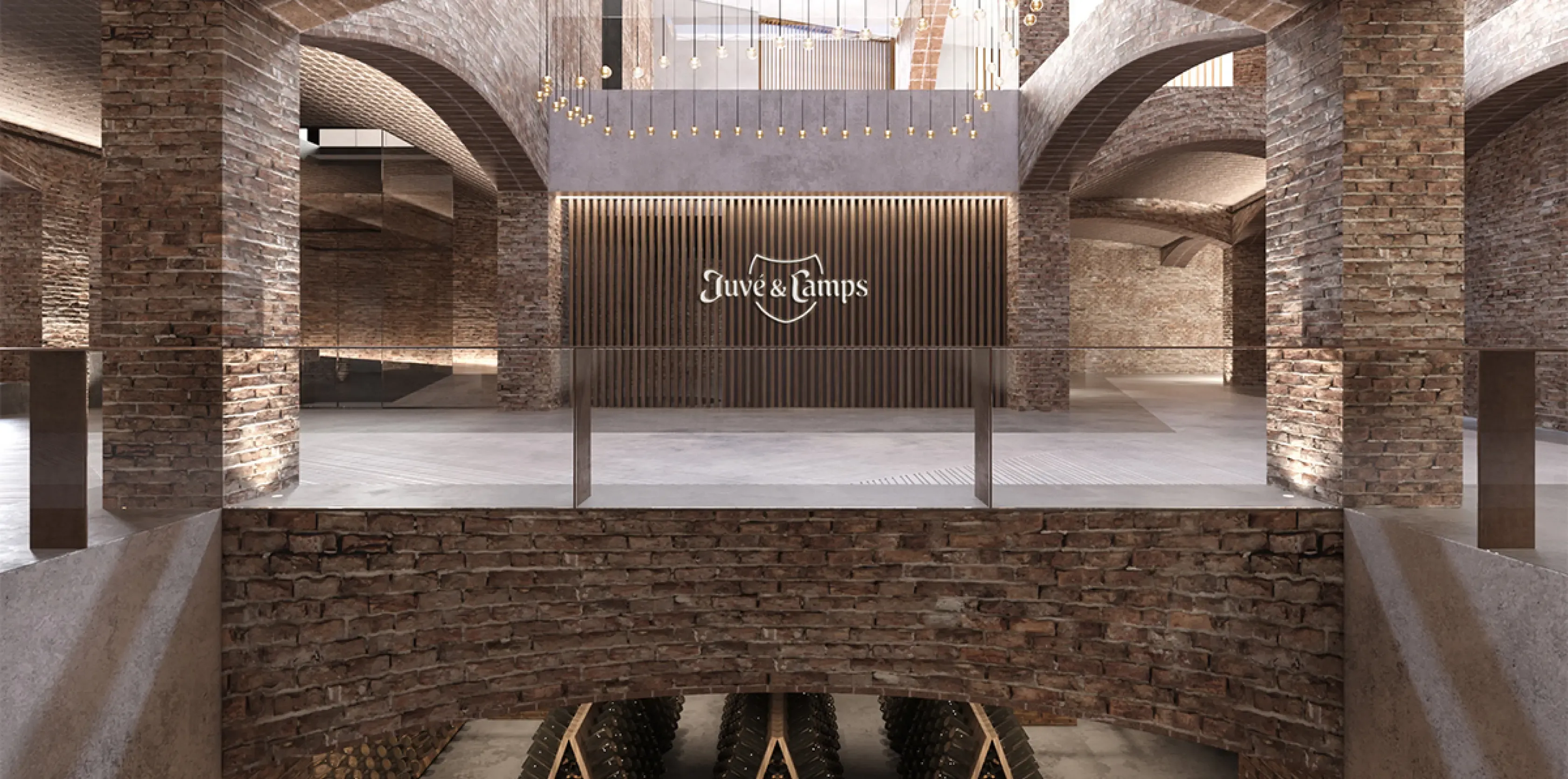 Lobby space with suspended lighting and wood slatted feature wall with Juvé & Camps logo.
