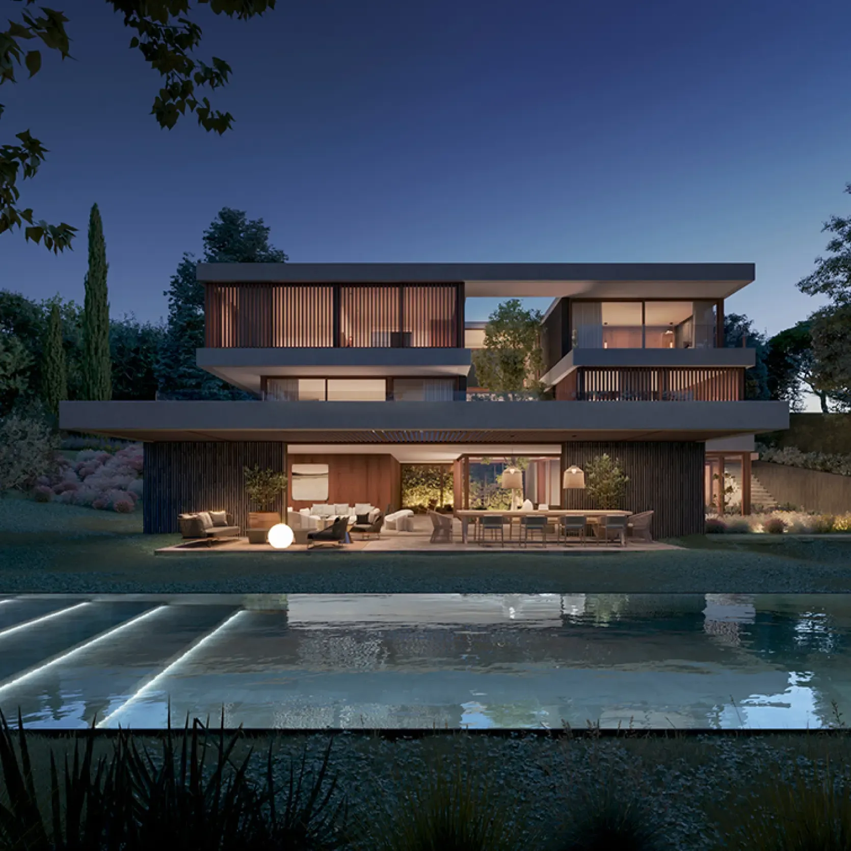 Nighttime view of Pearson K Villa with warm lighting and illuminated pool