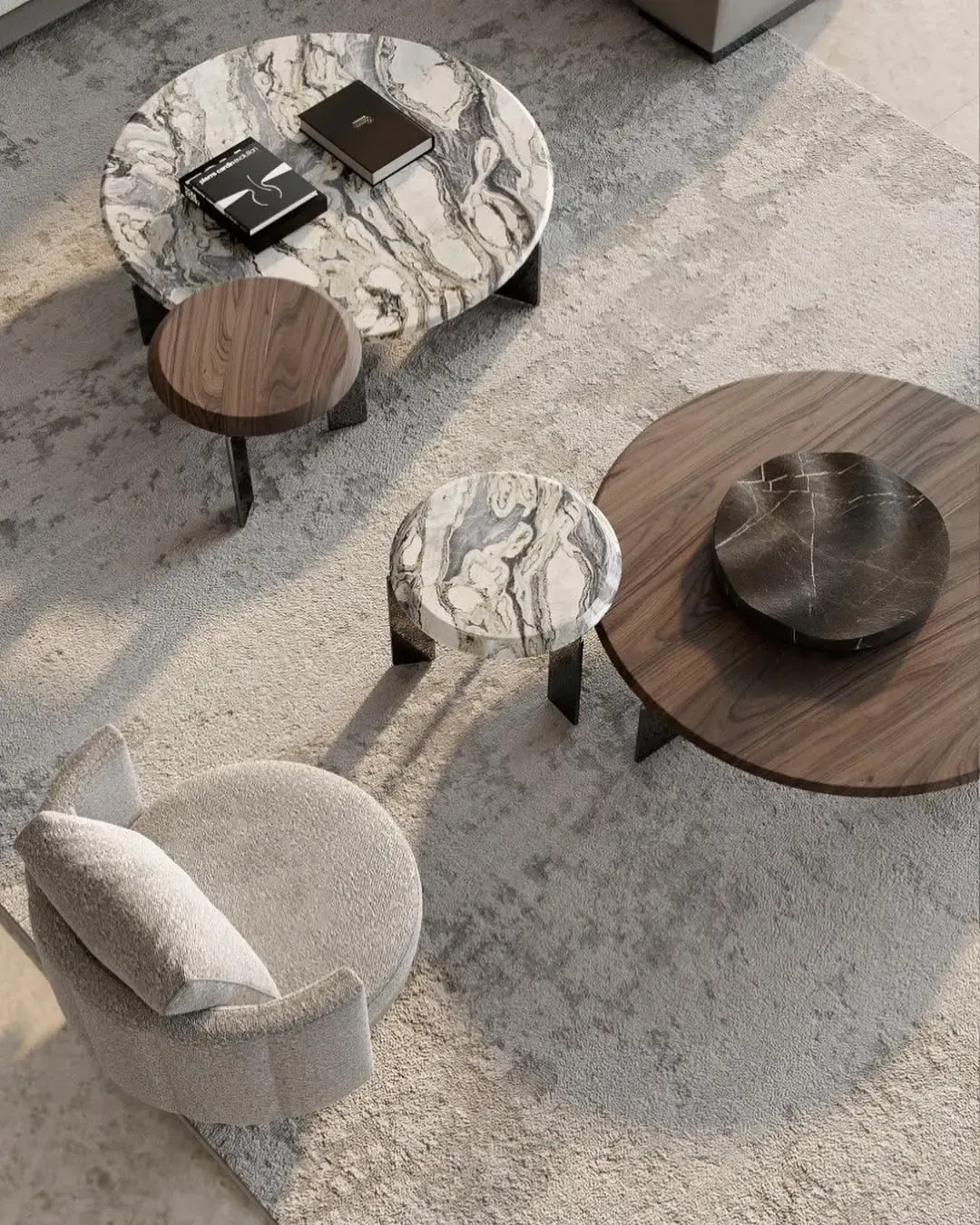 Mix of marble and wood coffee tables in a modern living area.