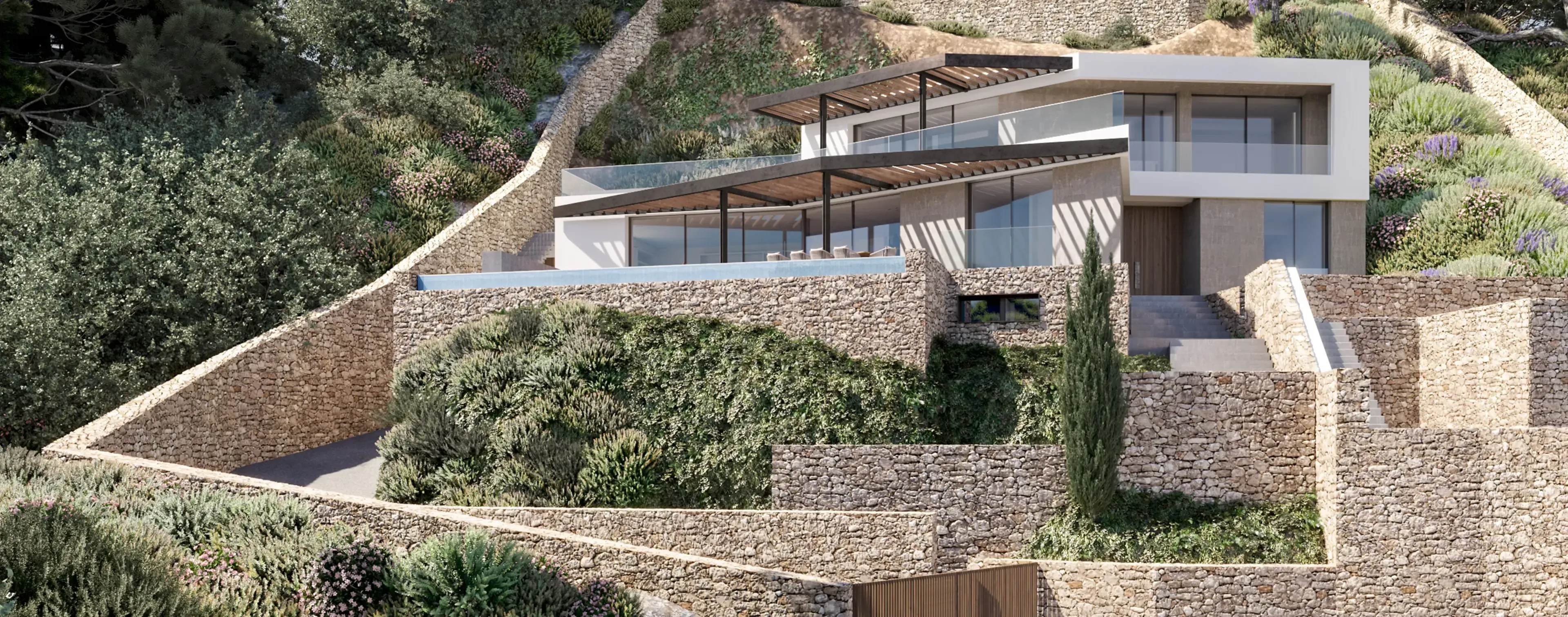 Contemporary hillside villa by Luv Studio in Menorca, featuring layered stone terraces and panoramic views.