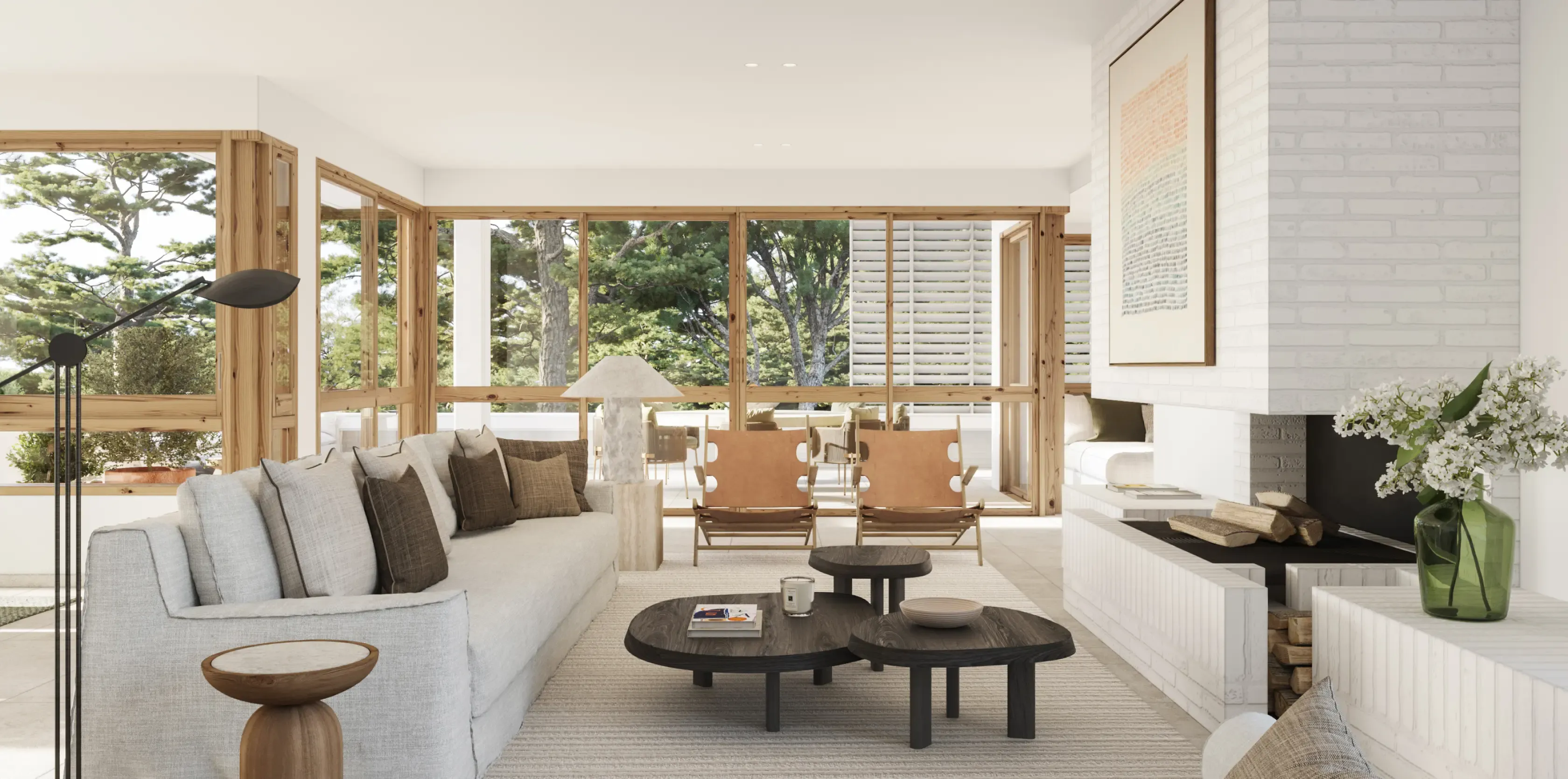 Cozy luxury living room with a fireplace, neutral tones, and large windows opening to lush greenery.