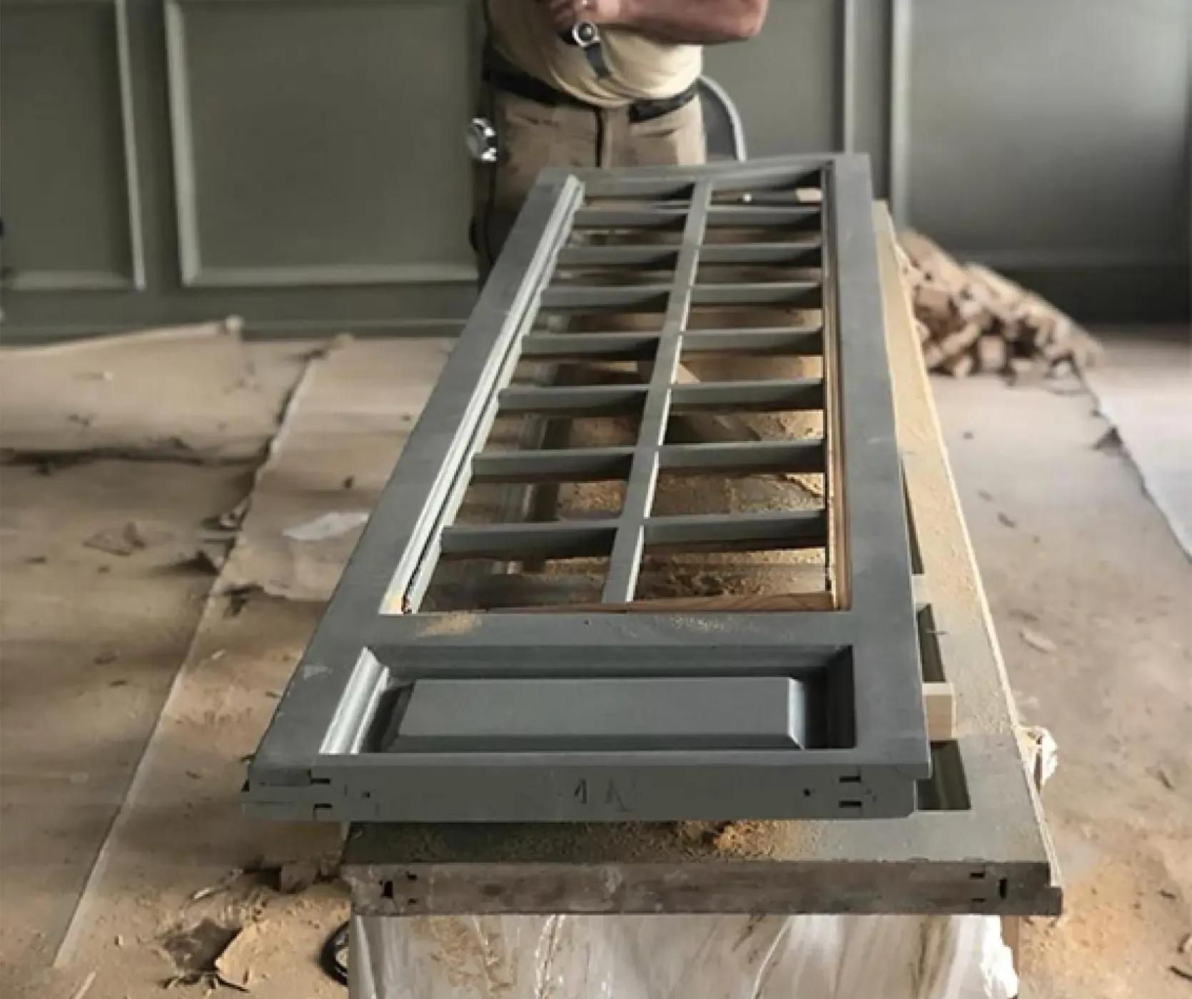 Craftsman installing custom woodwork for a high-end office renovation in central Barcelona.